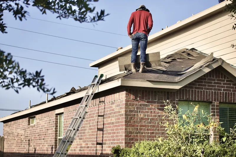 Professional roofer working on a residential roof in Delavan